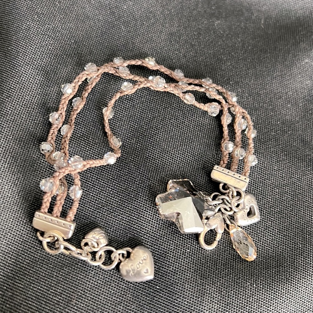 Brighton multi strand, brown cord with clear beads sewn in . Cross pendant